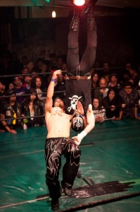 Juiced Lee delivers a brain buster to Lucha Magnifico